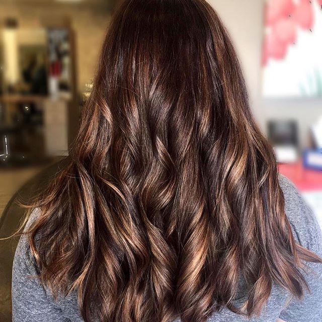 These beautiful strands of caramel add the perfect glow and contrast to her rich espresso color. We added four different colors to achieve all this dimension and finished with a gloss for all that shine. Caramel Macchiato hair color by stylist Jessica Gossard of My Hair Therapy Sandy Luxury Hair Salon